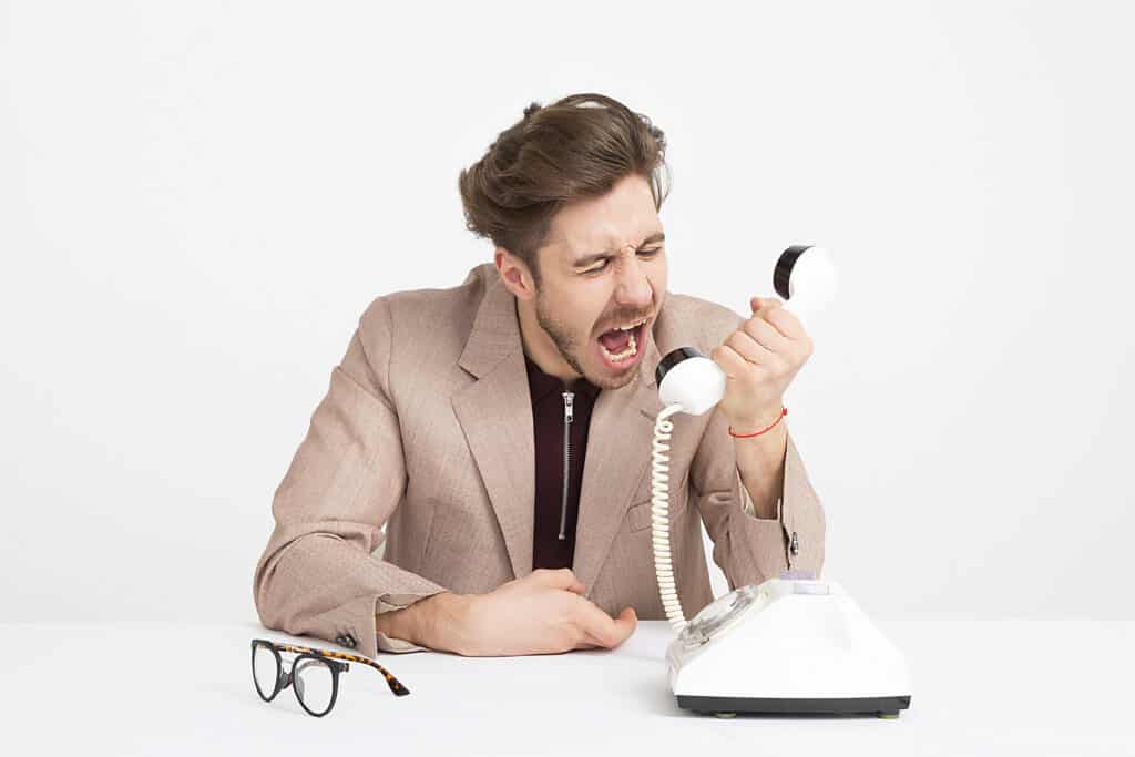 Office worker, Handsome young man shouting into telephone, Spiritual Warfare In The Workplace: A Helpful Guide